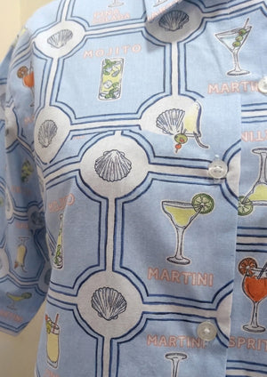 
                  
                    Light blue shirt with cocktail and shell pattern
                  
                