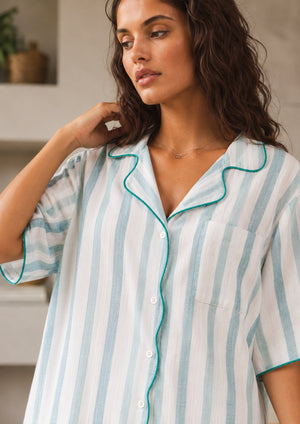 
                  
                    Woman wearing a striped pajama top in a home setting
                  
                